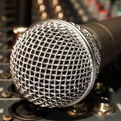 Closeup of a microphone on a mixing board