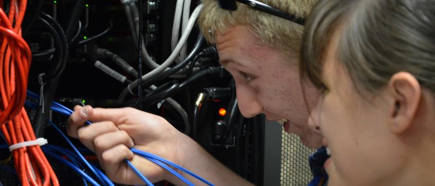 High School students pluuging in data cables